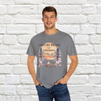 Campfire Dreams and Summer Memories Unisex Garment-Dyed T-shirt. Escape to the great outdoors with our Campfire Dreams and Summer Memories Garment-Dyed T-shirt. Made from soft, high-quality fabric, this shirt is perfect for cozy nights by the fire or creating unforgettable summer memories. Featuring the graphics of a scenery of a sunset, trees, patio lights, a fire pit and two wood chairs.