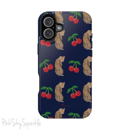 A stylish magnetic iPhone case featuring a unique pattern of leopards and bright red cherries on a dark navy blue background, blending bold and playful elements.