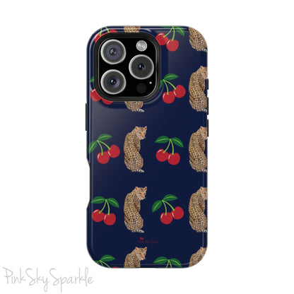 A stylish magnetic iPhone case featuring a unique pattern of leopards and bright red cherries on a dark navy blue background, blending bold and playful elements.