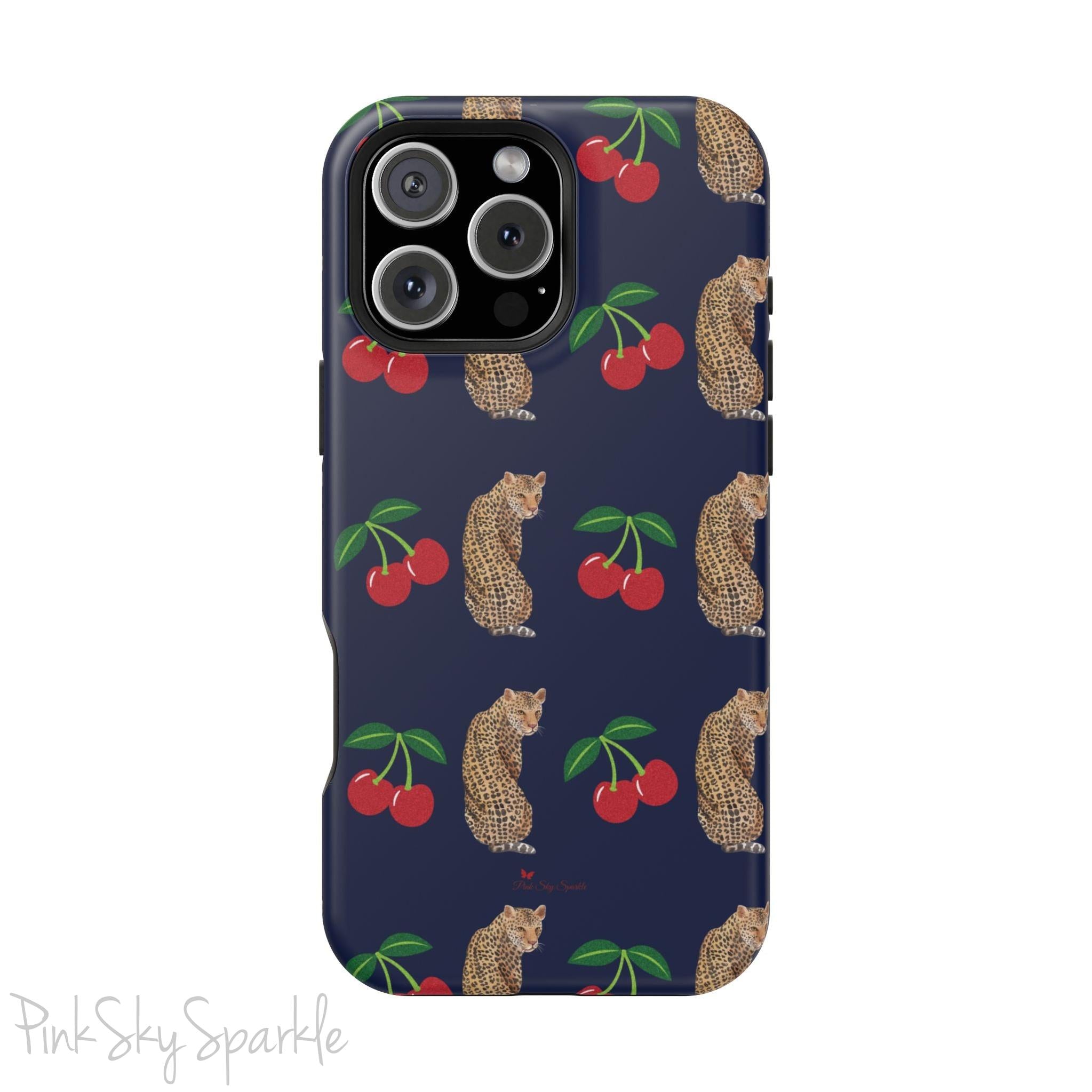 A stylish magnetic iPhone case featuring a unique pattern of leopards and bright red cherries on a dark navy blue background, blending bold and playful elements.