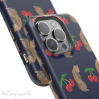 A stylish magnetic iPhone case featuring a unique pattern of leopards and bright red cherries on a dark navy blue background, blending bold and playful elements.