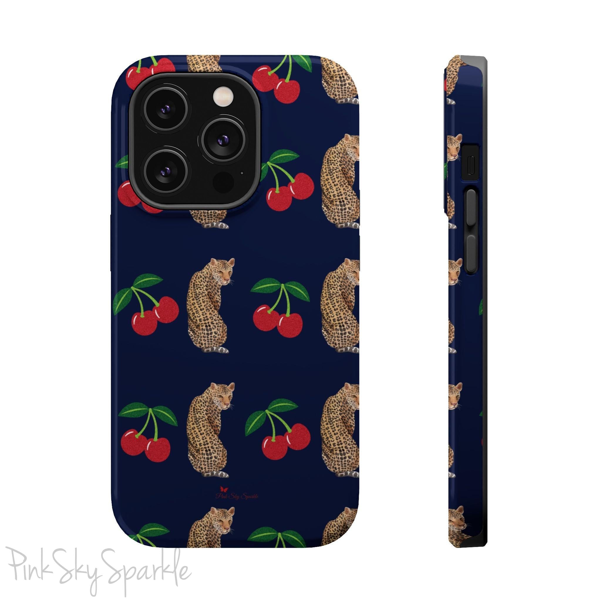 A stylish magnetic iPhone case featuring a unique pattern of leopards and bright red cherries on a dark navy blue background, blending bold and playful elements.