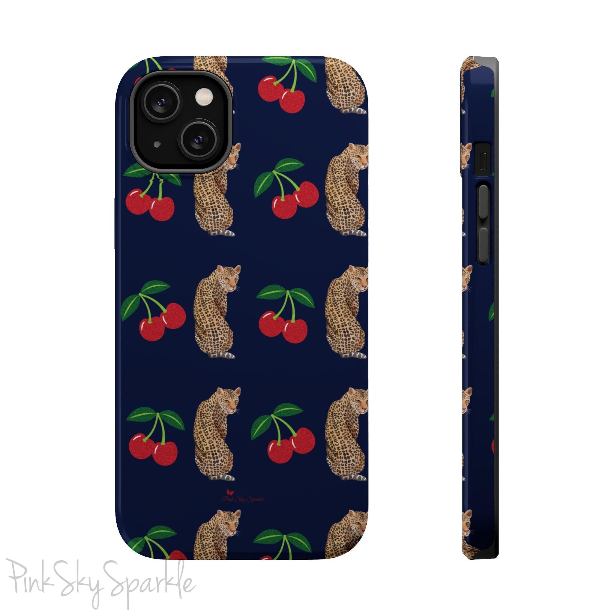 A stylish magnetic iPhone case featuring a unique pattern of leopards and bright red cherries on a dark navy blue background, blending bold and playful elements.