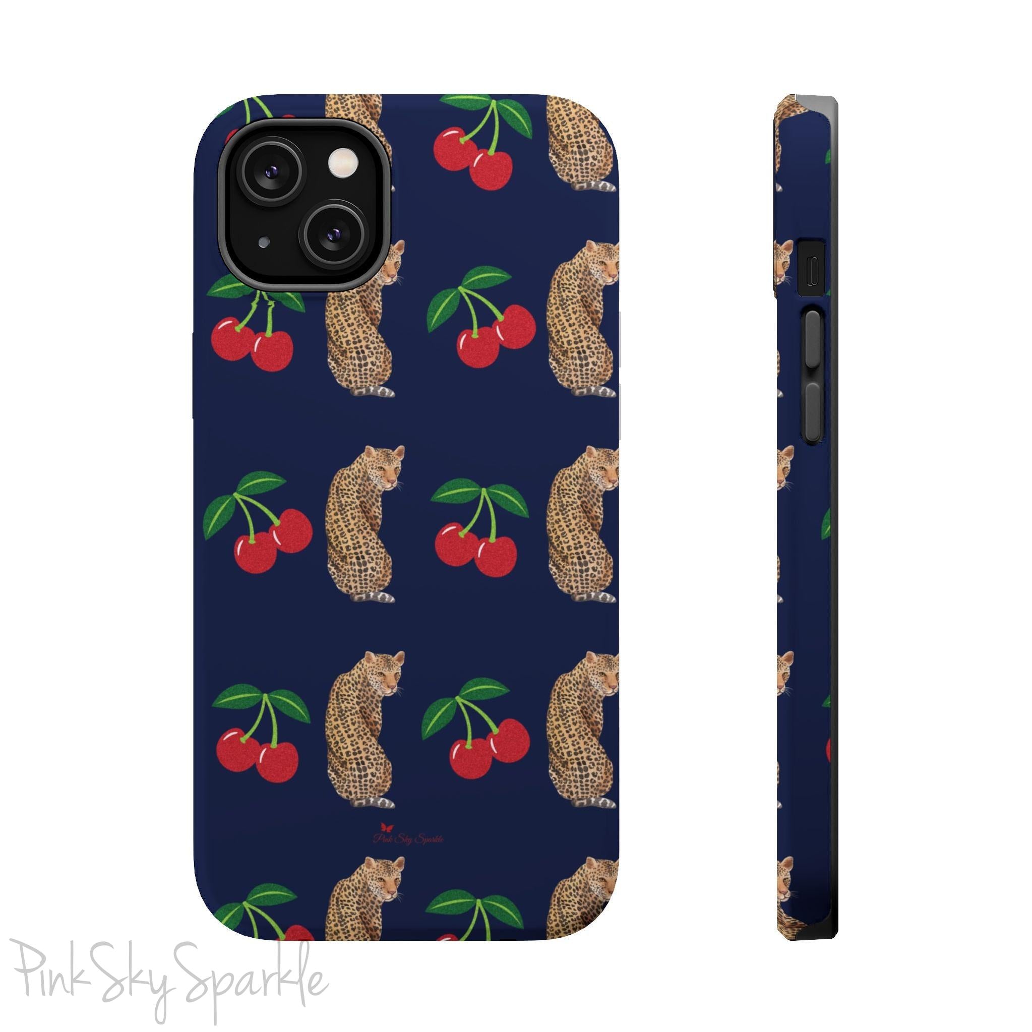 A stylish magnetic iPhone case featuring a unique pattern of leopards and bright red cherries on a dark navy blue background, blending bold and playful elements.