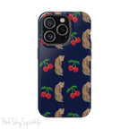 A stylish magnetic iPhone case featuring a unique pattern of leopards and bright red cherries on a dark navy blue background, blending bold and playful elements.