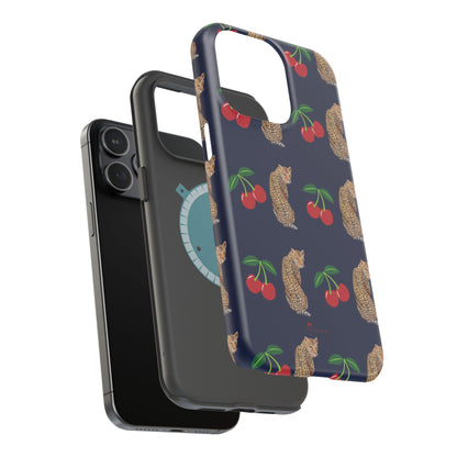 A stylish magnetic iPhone case featuring a unique pattern of leopards and bright red cherries on a dark navy blue background, blending bold and playful elements.