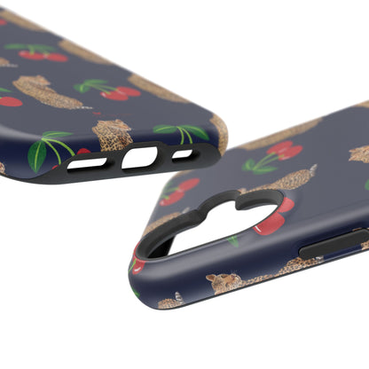 A stylish magnetic iPhone case featuring a unique pattern of leopards and bright red cherries on a dark navy blue background, blending bold and playful elements.