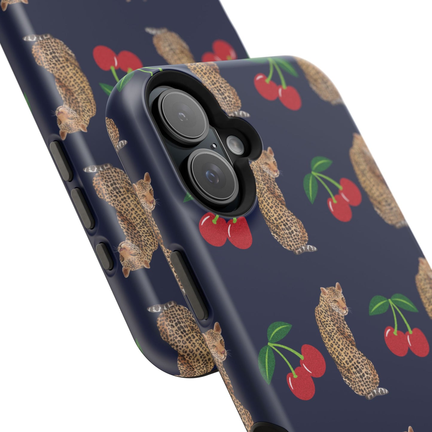 A stylish magnetic iPhone case featuring a unique pattern of leopards and bright red cherries on a dark navy blue background, blending bold and playful elements.