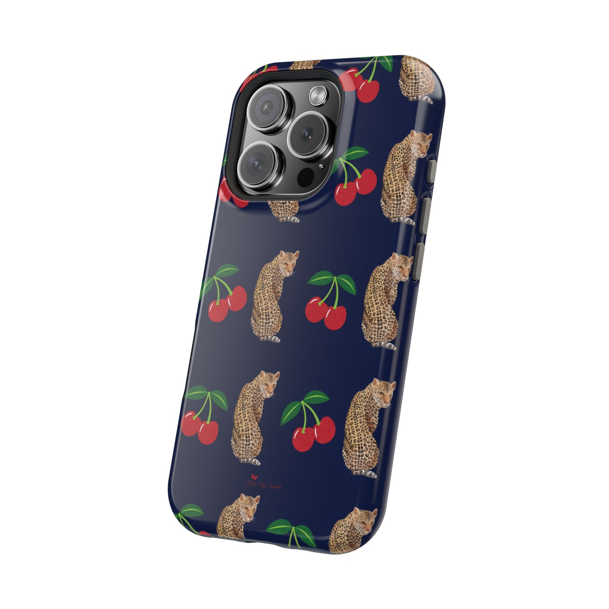 A stylish magnetic iPhone case featuring a unique pattern of leopards and bright red cherries on a dark navy blue background, blending bold and playful elements.