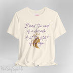 Embrace the excitement of a new era with our End of a Decade, Start of an Age T-shirt, inspired by Taylor Swift's iconic lyrics. Featuring the words It was the end of a decade, But the start of an age in a purple marker script font with a gold silhouette of a woman wearing a crown.