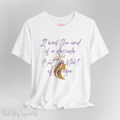 Embrace the excitement of a new era with our End of a Decade, Start of an Age T-shirt, inspired by Taylor Swift's iconic lyrics. Featuring the words It was the end of a decade, But the start of an age in a purple marker script font with a gold silhouette of a woman wearing a crown.