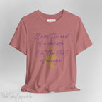 Embrace the excitement of a new era with our End of a Decade, Start of an Age T-shirt, inspired by Taylor Swift's iconic lyrics. Featuring the words It was the end of a decade, But the start of an age in a purple marker script font with a gold silhouette of a woman wearing a crown.