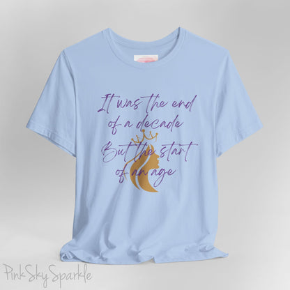 Embrace the excitement of a new era with our End of a Decade, Start of an Age T-shirt, inspired by Taylor Swift's iconic lyrics. Featuring the words It was the end of a decade, But the start of an age in a purple marker script font with a gold silhouette of a woman wearing a crown.