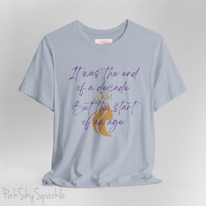 Embrace the excitement of a new era with our End of a Decade, Start of an Age T-shirt, inspired by Taylor Swift's iconic lyrics. Featuring the words It was the end of a decade, But the start of an age in a purple marker script font with a gold silhouette of a woman wearing a crown.