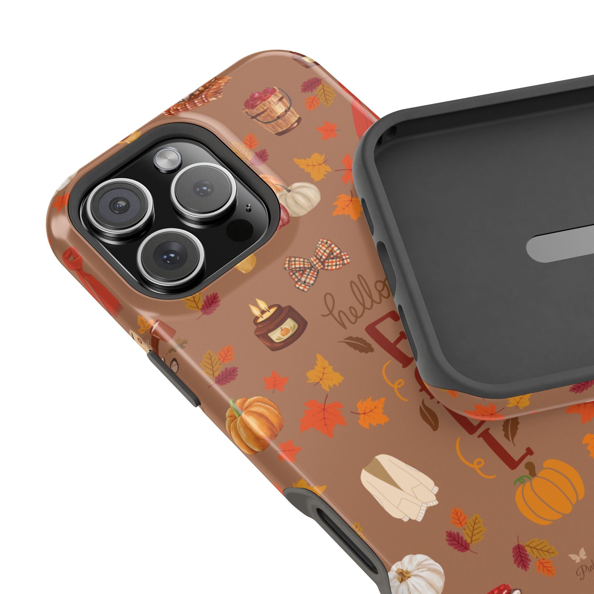 Phone case with autumn-themed design featuring pumpkins, leaves, and a bow on a brown background.