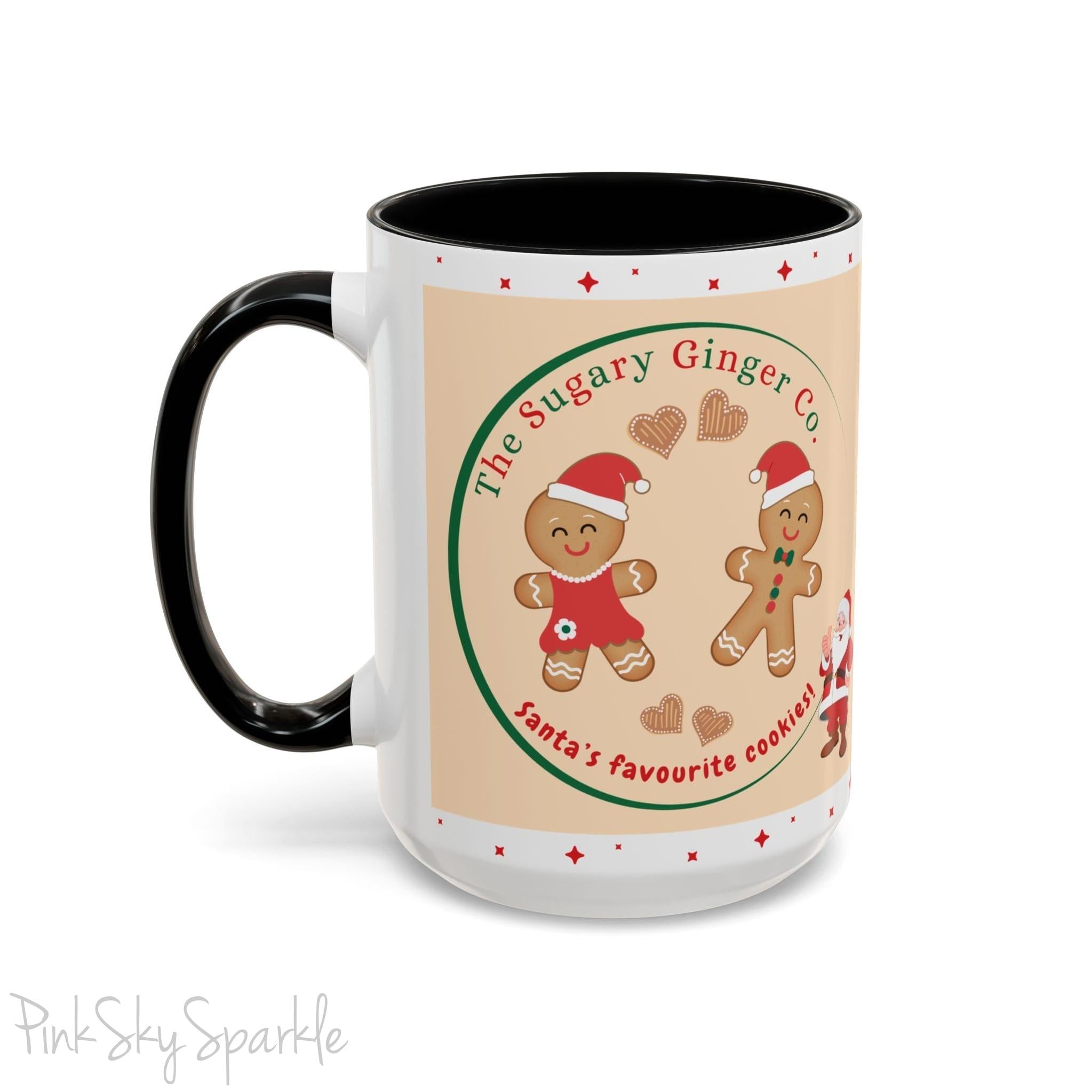 Holiday Gingerbread Coffee Mug featuring a male and female gingerbread cookies next to Santa with giving a thumbs up and the writing The Sugary Ginger Co. written at the top and Santa's favourite cookies at the bottom. The mug has a black handle and black interior. 