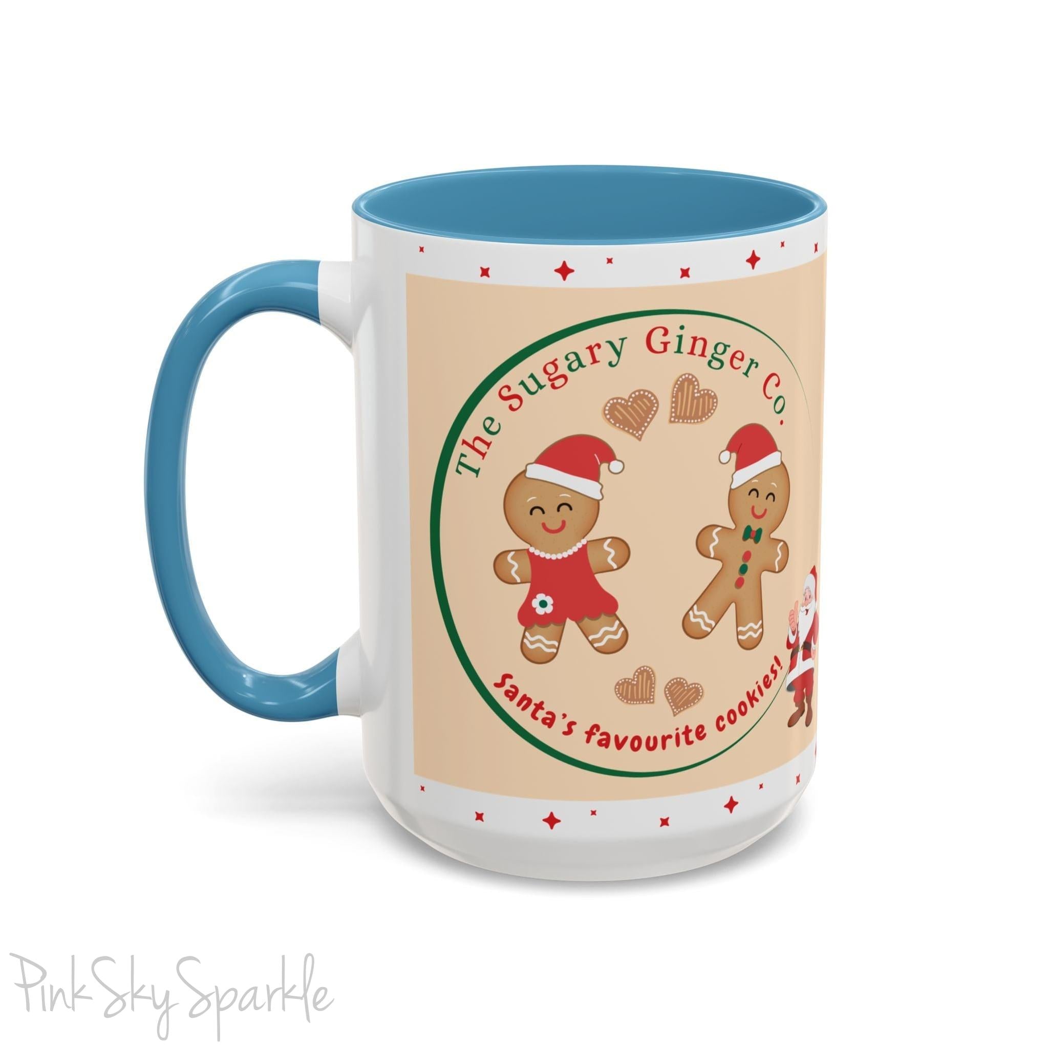 Holiday Gingerbread Coffee Mug featuring a male and female gingerbread cookies next to Santa with giving a thumbs up and the writing The Sugary Ginger Co. written at the top and Santa's favourite cookies at the bottom. The mug has a light blue handle and light blue interior. 
