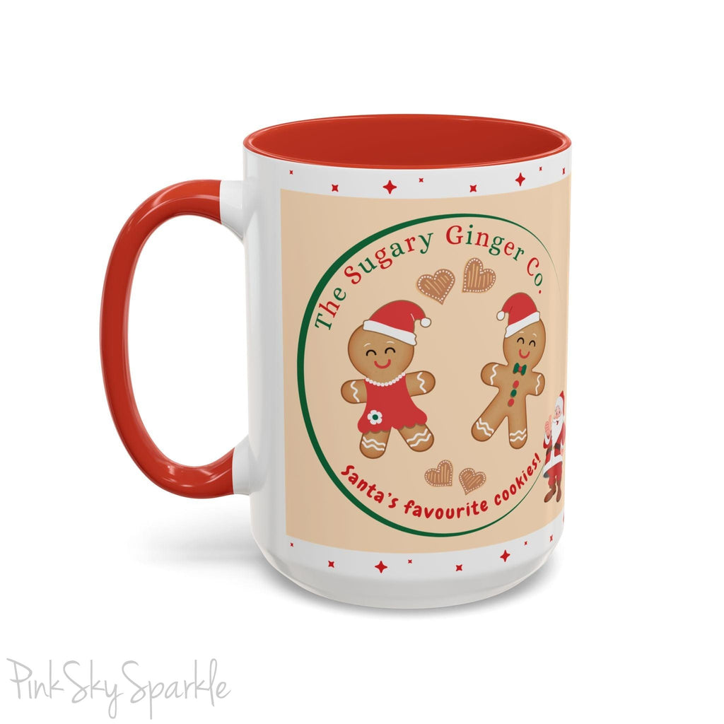 Holiday Gingerbread Coffee Mug featuring a male and female gingerbread cookies next to Santa with giving a thumbs up and the writing The Sugary Ginger Co. written at the top and Santa's favourite cookies at the bottom. The mug has a red handle and red interior. 