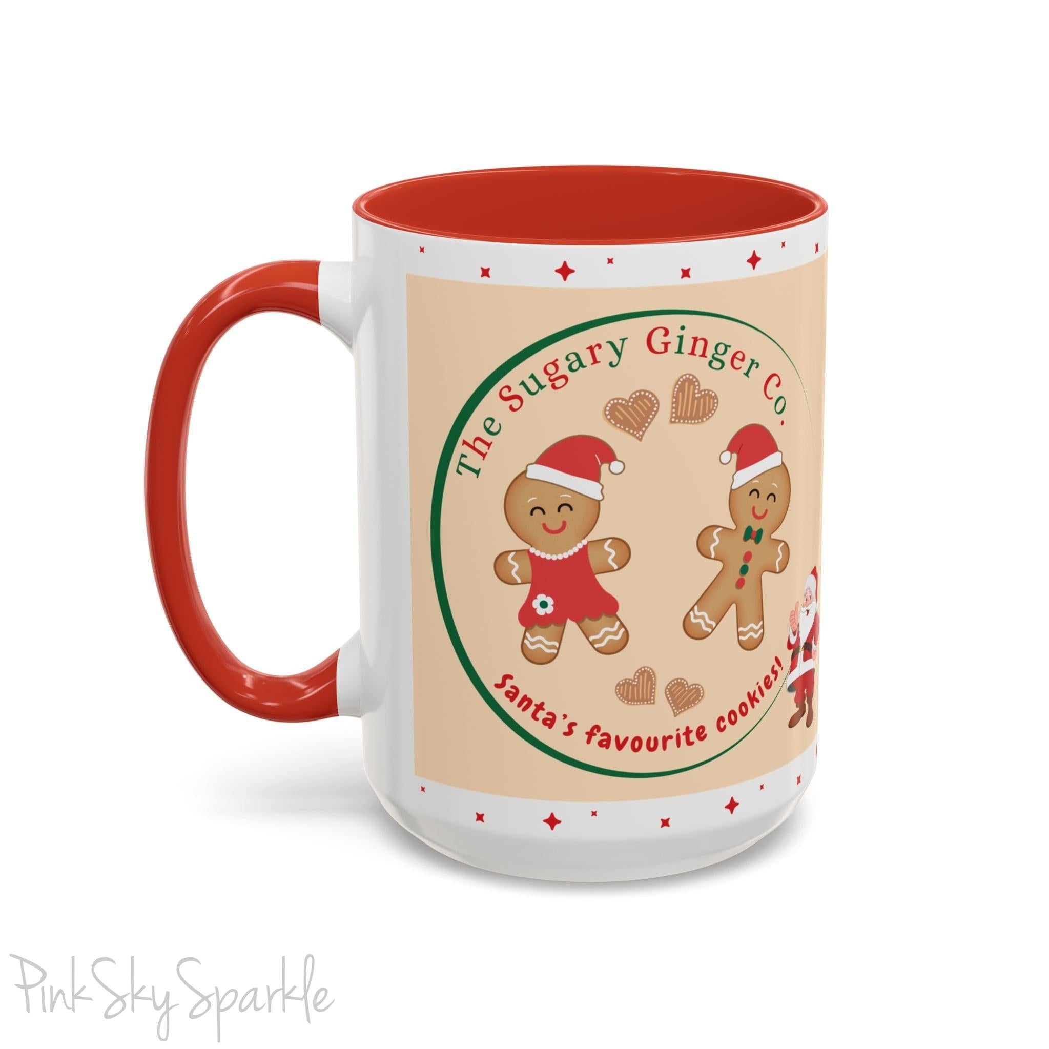Holiday Gingerbread Coffee Mug featuring a male and female gingerbread cookies next to Santa with giving a thumbs up and the writing The Sugary Ginger Co. written at the top and Santa's favourite cookies at the bottom. The mug has a red handle and red interior. 
