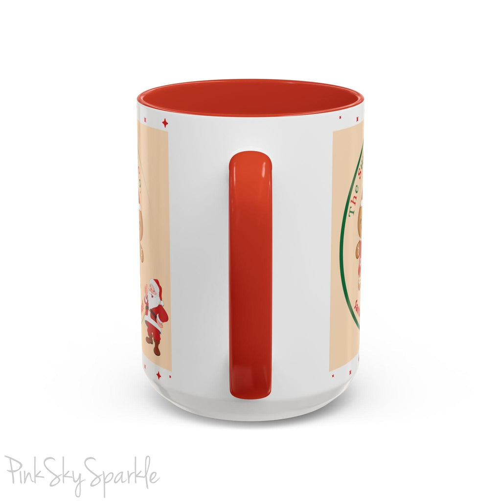 Holiday Gingerbread Coffee Mug featuring a male and female gingerbread cookies next to Santa with giving a thumbs up and the writing The Sugary Ginger Co. written at the top and Santa's favourite cookies at the bottom. The mug has a red handle and red interior. 