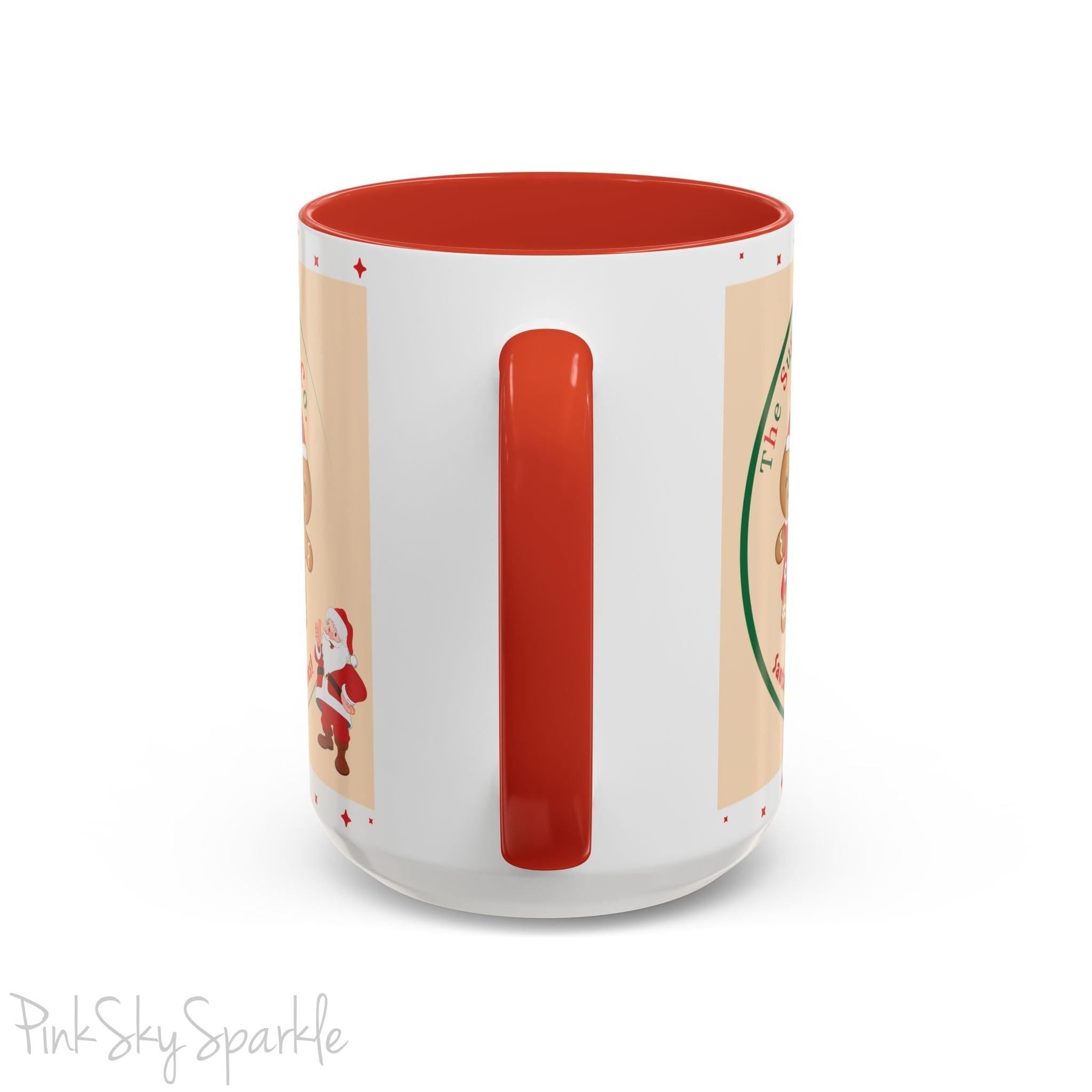 Holiday Gingerbread Coffee Mug featuring a male and female gingerbread cookies next to Santa with giving a thumbs up and the writing The Sugary Ginger Co. written at the top and Santa's favourite cookies at the bottom. The mug has a red handle and red interior. 