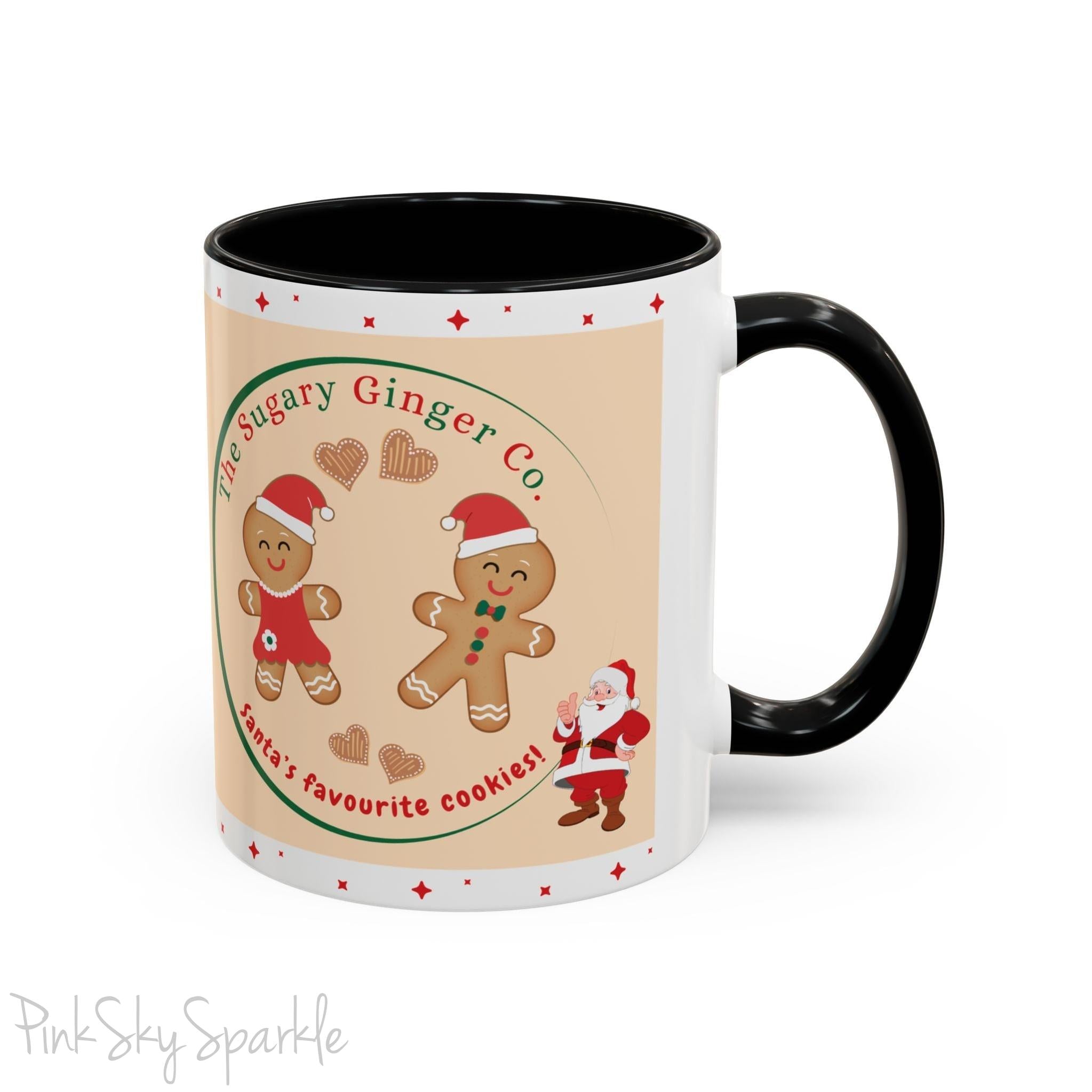 Holiday Gingerbread Coffee Mug featuring a male and female gingerbread cookies next to Santa with giving a thumbs up and the writing The Sugary Ginger Co. written at the top and Santa's favourite cookies at the bottom. The mug has a black handle and black interior. 