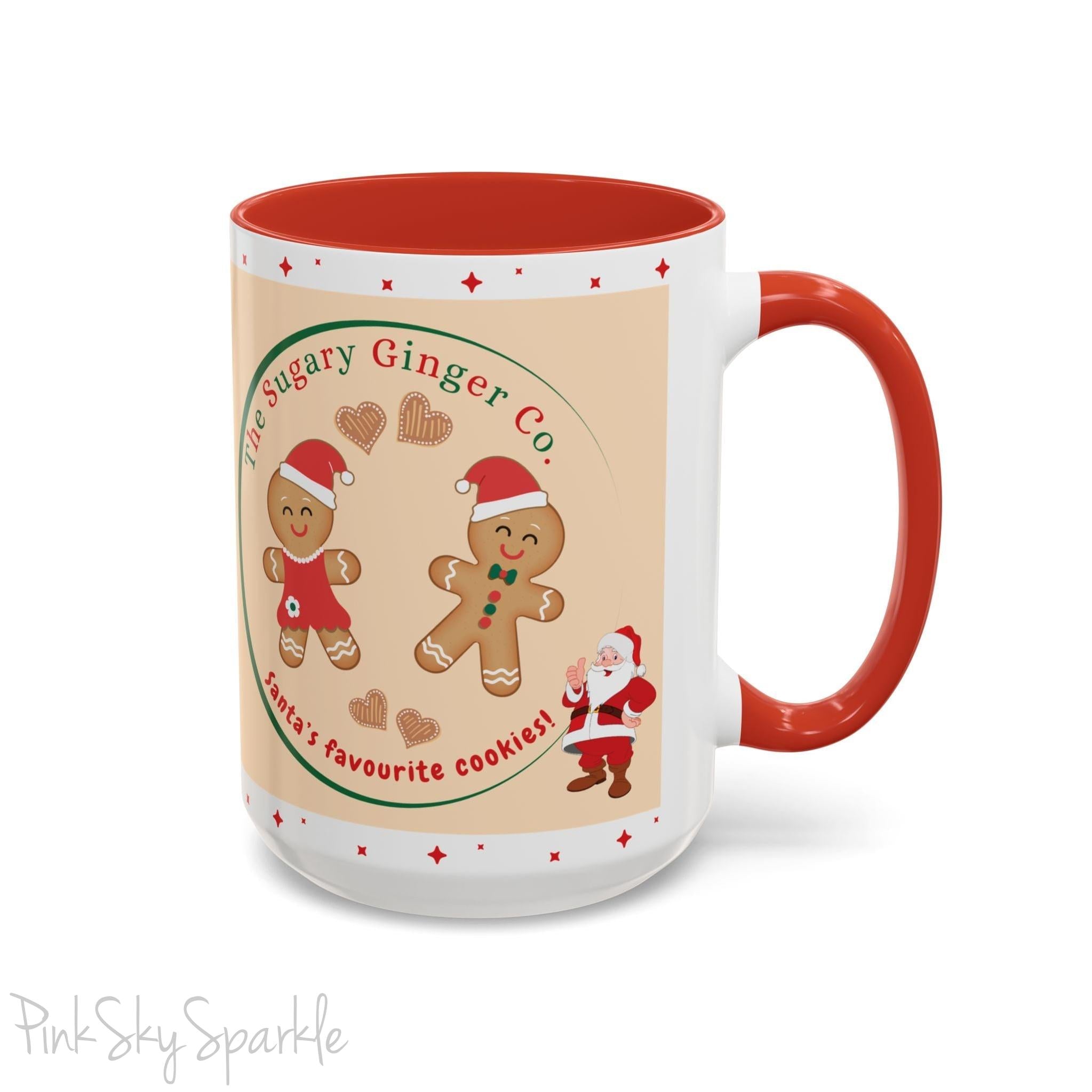 Holiday Gingerbread Coffee Mug featuring a male and female gingerbread cookies next to Santa with giving a thumbs up and the writing The Sugary Ginger Co. written at the top and Santa's favourite cookies at the bottom. The mug has a red handle and red interior. 