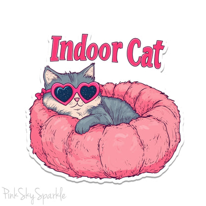 Indoor Cat Waterproof Sticker - Cute sticker of a cat in a pink bed with heart-shaped glasses, perfect for laptops, water bottles, planners, and more. Durable, waterproof vinyl with scratch-resistant lamination. Ideal for cat lovers and unique decor.