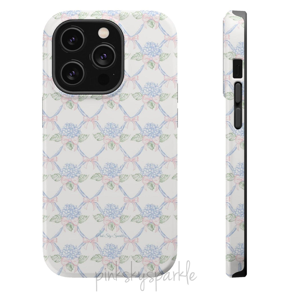 Blue hydrangea lattice with pink bows on a white MagSafe iPhone case — coquette floral design.