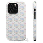 Blue hydrangea lattice with pink bows on a white MagSafe iPhone case — coquette floral design.