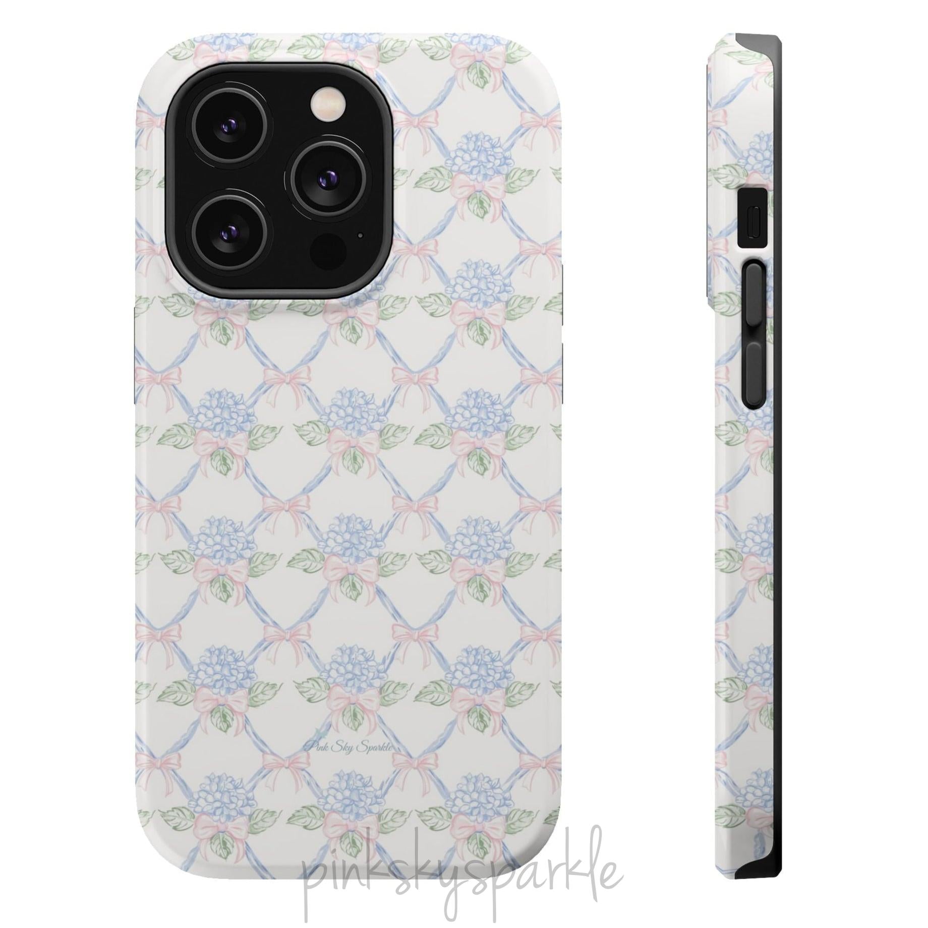 Blue hydrangea lattice with pink bows on a white MagSafe iPhone case — coquette floral design.
