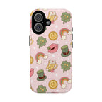 Magnetic iPhone case with a pastel pink background featuring lucky four-leaf clovers, gold coins, rainbows, leprechaun hats, beer mugs, and lips with shamrock details. A festive and playful St. Patrick’s Day design.