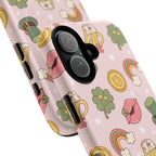 Magnetic iPhone case with a pastel pink background featuring lucky four-leaf clovers, gold coins, rainbows, leprechaun hats, beer mugs, and lips with shamrock details. A festive and playful St. Patrick’s Day design.