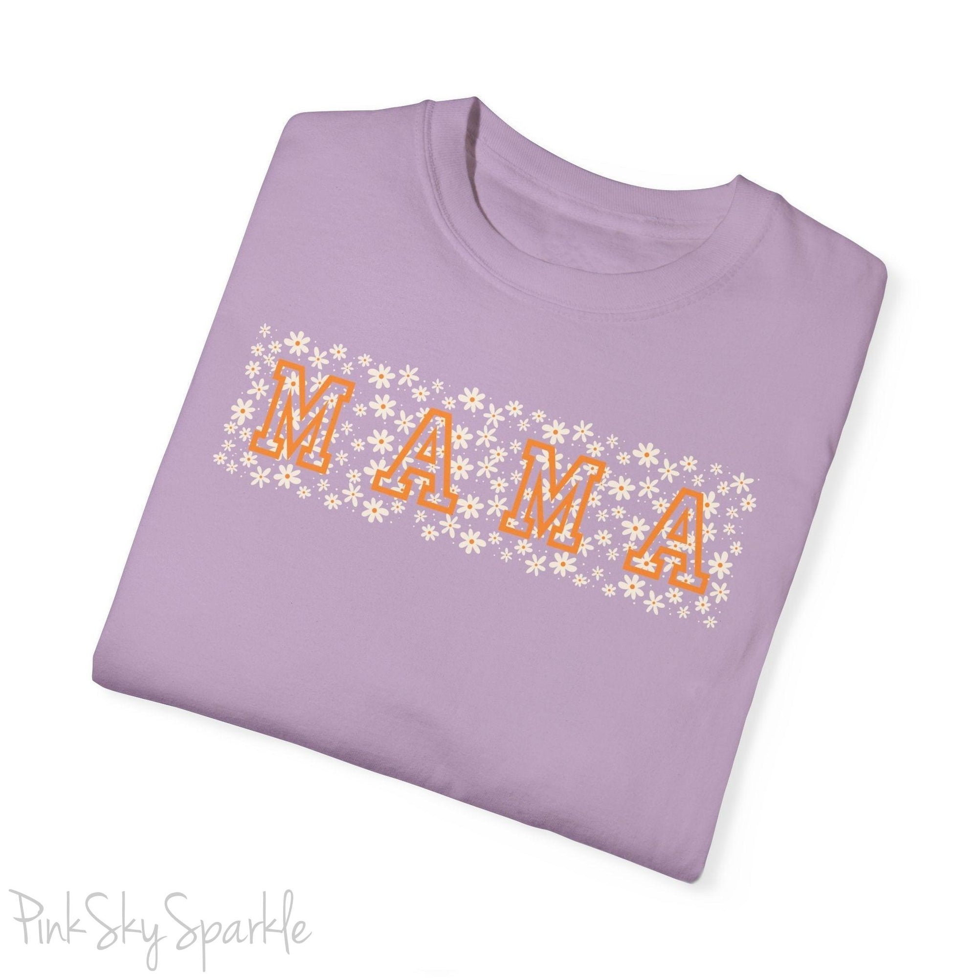 The bold 'MAMA' lettering, overlaid on a charming daisy pattern, makes this shirt a standout piece. Whether you're running errands, meeting friends for coffee, or just enjoying a quiet day at home, this t-shirt is your go-to for effortless style.&nbsp;