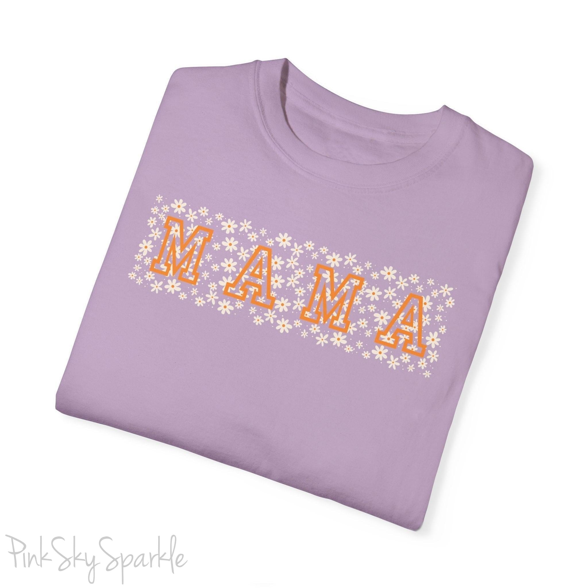 The bold 'MAMA' lettering, overlaid on a charming daisy pattern, makes this shirt a standout piece. Whether you're running errands, meeting friends for coffee, or just enjoying a quiet day at home, this t-shirt is your go-to for effortless style.&nbsp;
