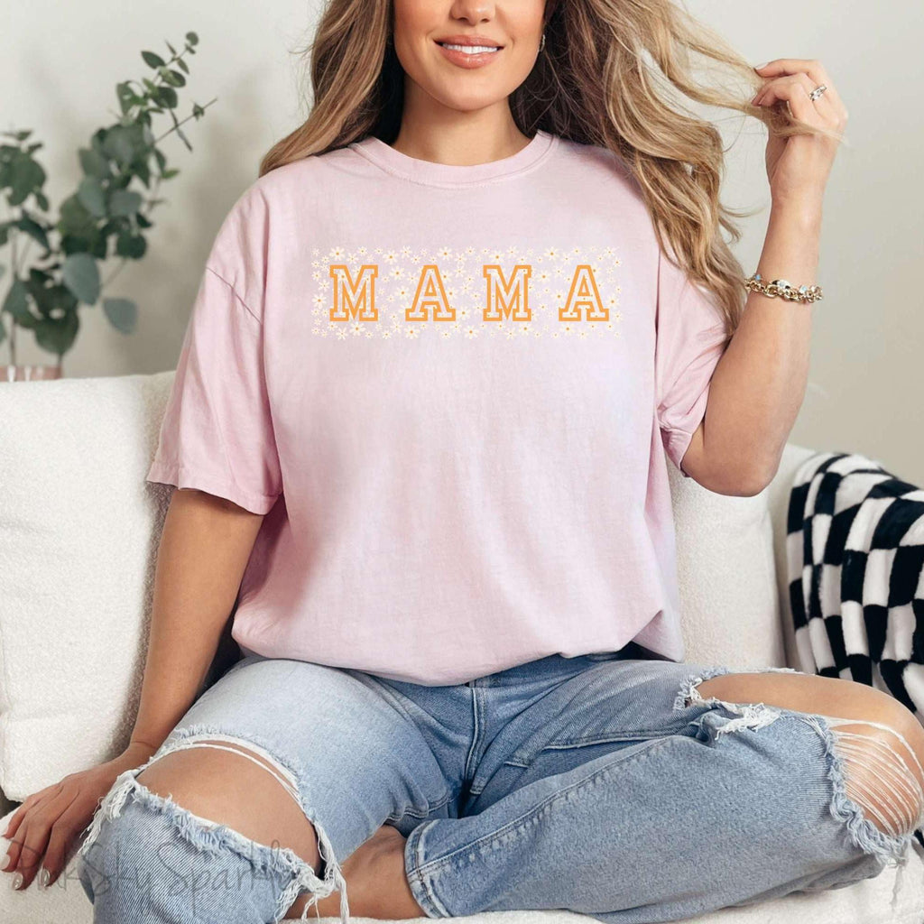 The bold 'MAMA' lettering, overlaid on a charming daisy pattern, makes this shirt a standout piece. Whether you're running errands, meeting friends for coffee, or just enjoying a quiet day at home, this t-shirt is your go-to for effortless style.&nbsp;