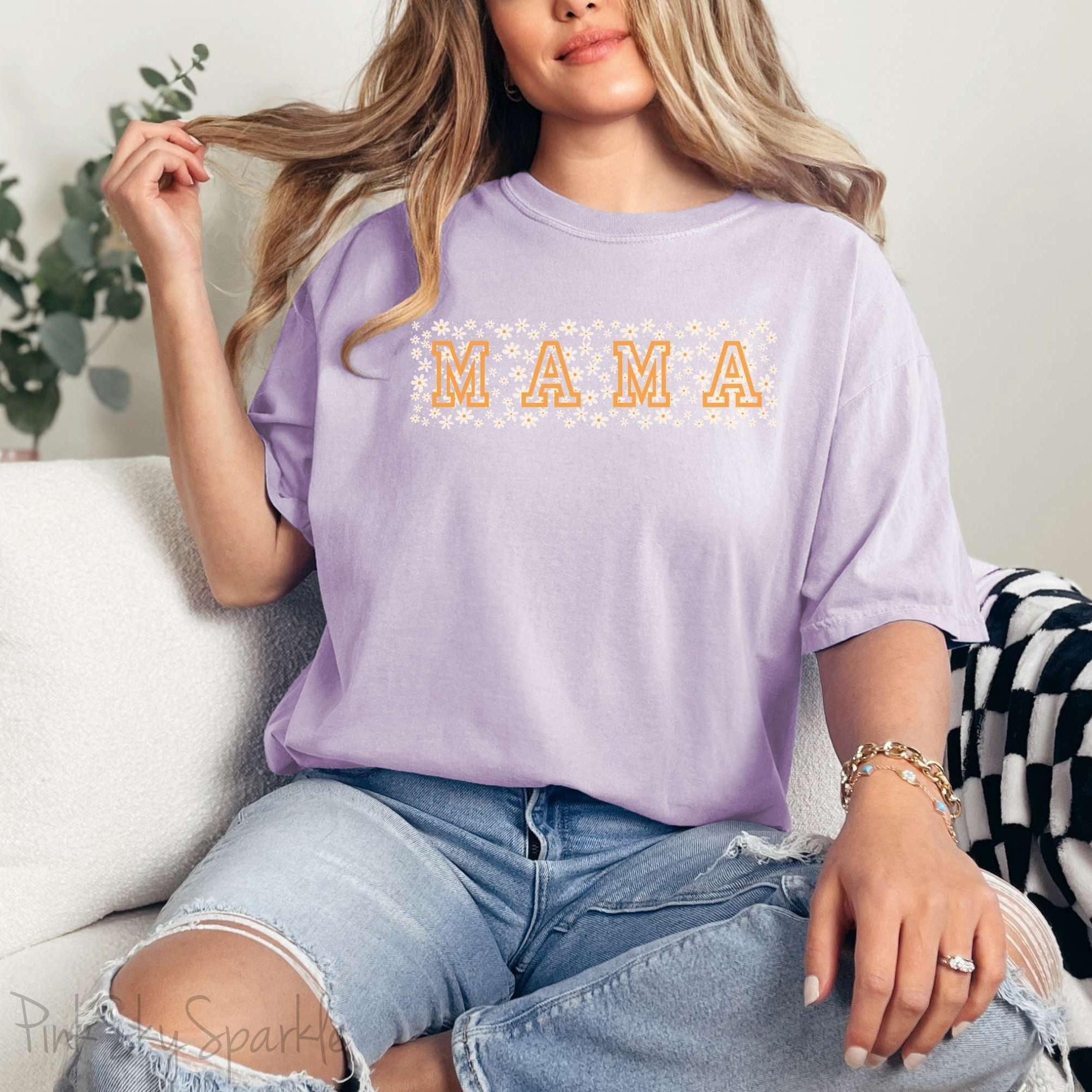 The bold 'MAMA' lettering, overlaid on a charming daisy pattern, makes this shirt a standout piece. Whether you're running errands, meeting friends for coffee, or just enjoying a quiet day at home, this t-shirt is your go-to for effortless style.&nbsp;