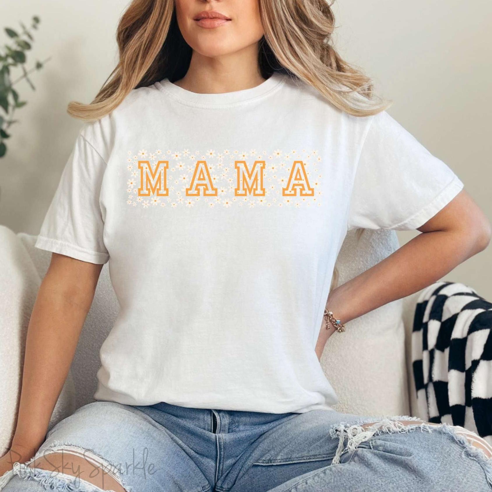 The bold 'MAMA' lettering, overlaid on a charming daisy pattern, makes this shirt a standout piece. Whether you're running errands, meeting friends for coffee, or just enjoying a quiet day at home, this t-shirt is your go-to for effortless style.&nbsp;