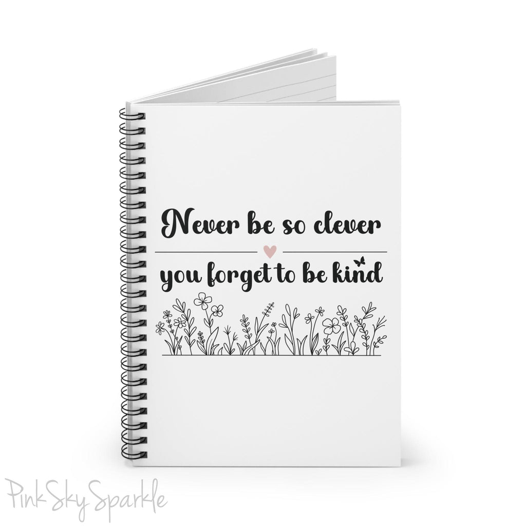 Spiral notebook with the quote "Never be so clever you forget to be kind" and flowers on it.
