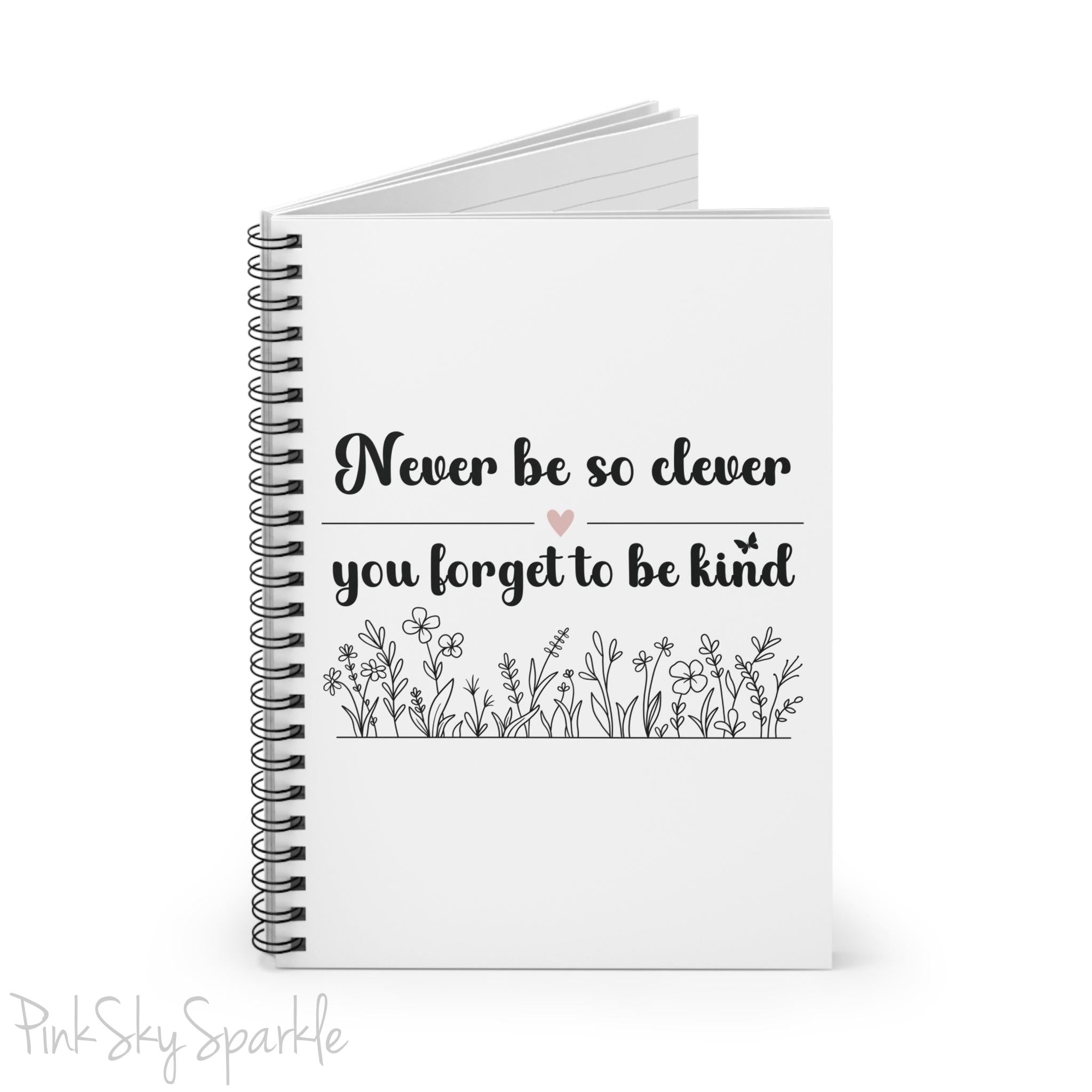 Spiral notebook with the quote "Never be so clever you forget to be kind" and flowers on it.