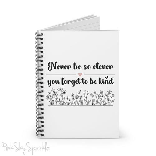 Spiral notebook with the quote "Never be so clever you forget to be kind" and flowers on it.