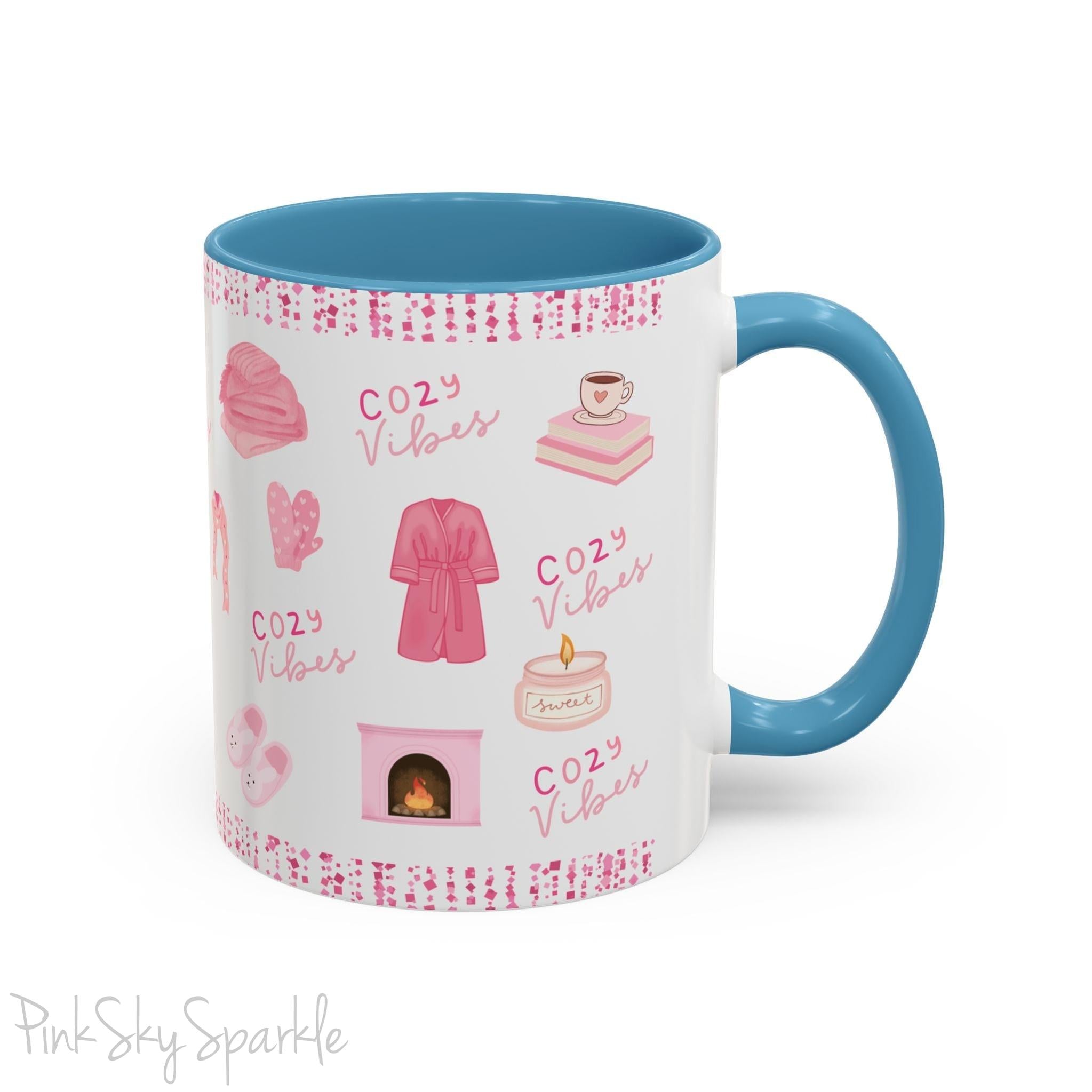 Pink Cozy Vibes Mug - Perfect for coffee, tea, or hot cocoa lovers! This ceramic mug features 'cozy vibes' in a pink font, surrounded by cute illustrations of pink cozy items such as slippers, mittens, blankets and candles. Ideal for creating a warm, cozy atmosphere, this pink-handled mug (also available in light blue, black and navy) makes a great gift for anyone who loves comfort, style and the color pink.