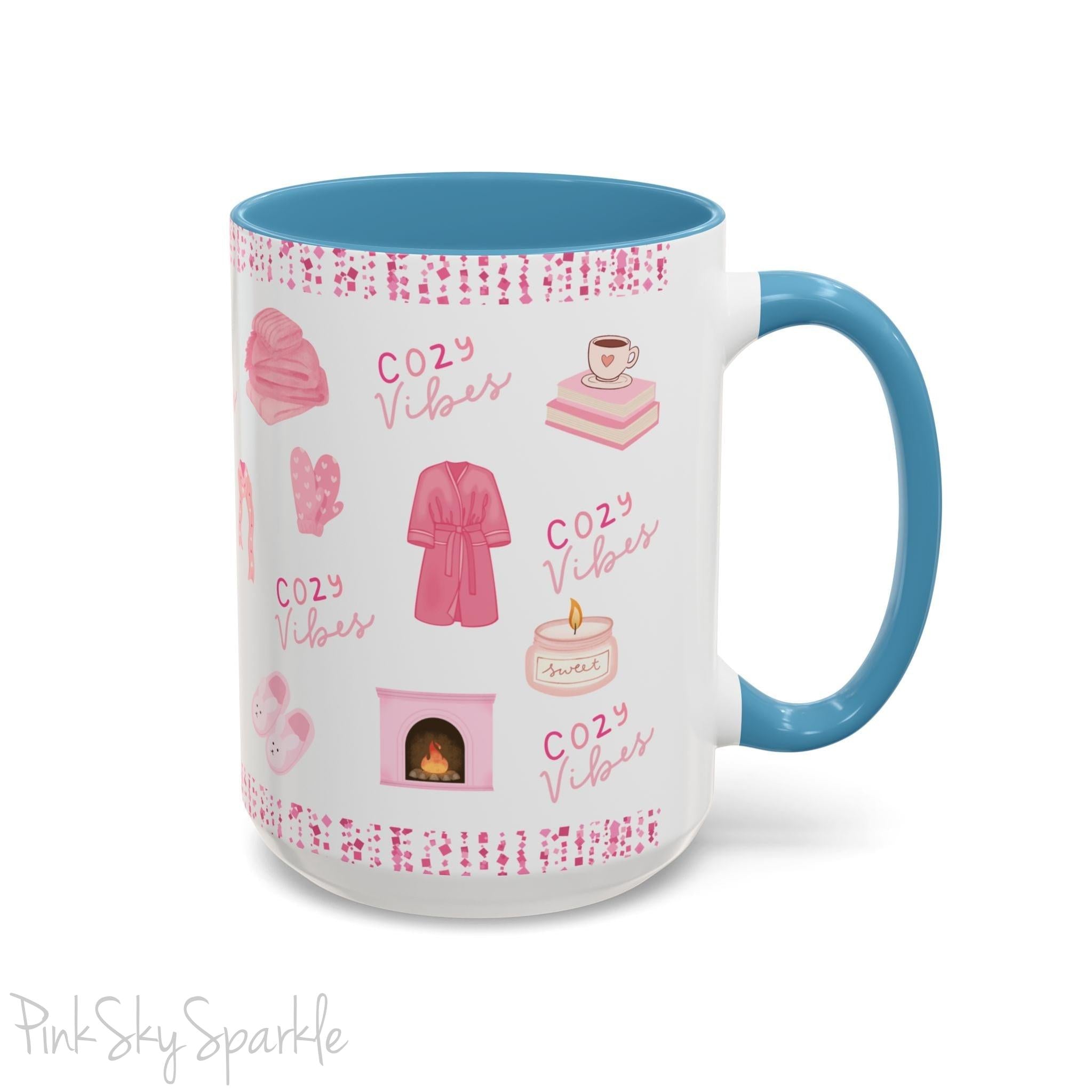 Pink Cozy Vibes Mug - Perfect for coffee, tea, or hot cocoa lovers! This ceramic mug features 'cozy vibes' in a pink font, surrounded by cute illustrations of pink cozy items such as slippers, mittens, blankets and candles. Ideal for creating a warm, cozy atmosphere, this pink-handled mug (also available in light blue, black and navy) makes a great gift for anyone who loves comfort, style and the color pink.
