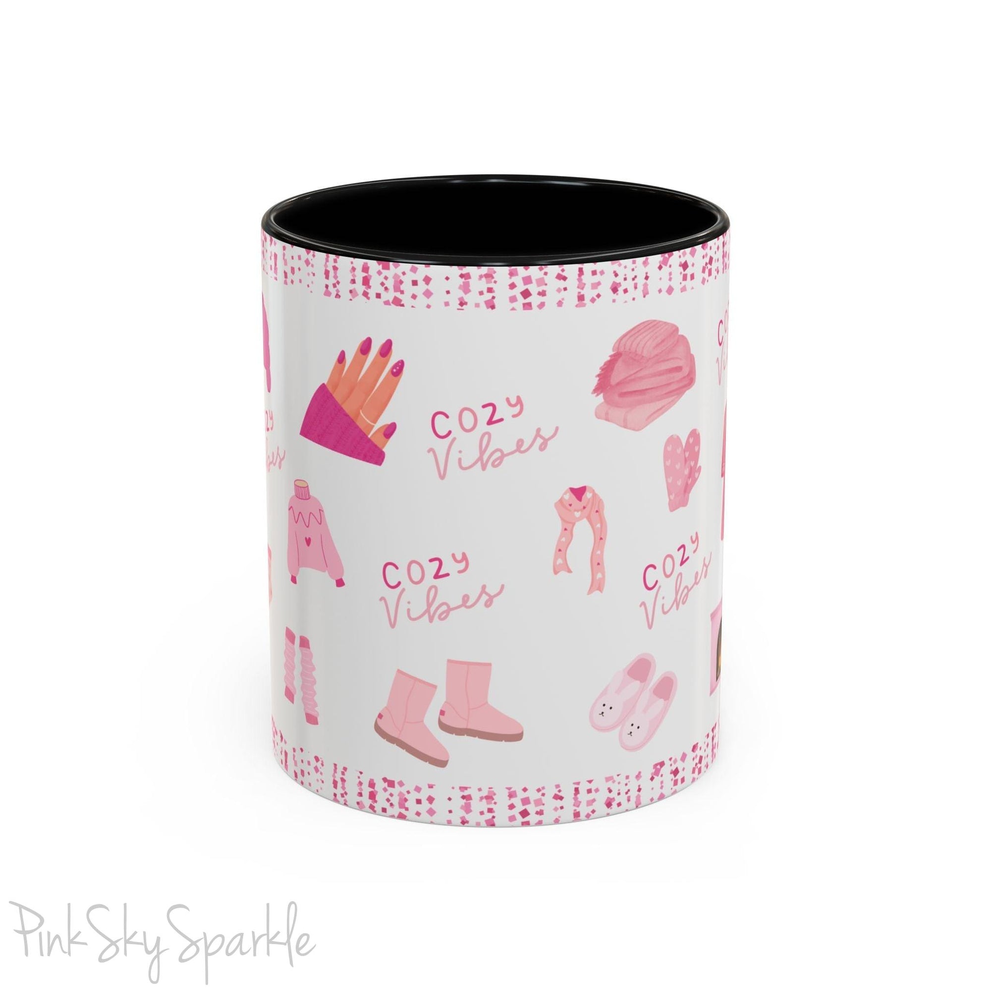 Pink Cozy Vibes Mug - Perfect for coffee, tea, or hot cocoa lovers! This ceramic mug features 'cozy vibes' in a pink font, surrounded by cute illustrations of pink cozy items such as slippers, mittens, blankets and candles. Ideal for creating a warm, cozy atmosphere, this pink-handled mug (also available in light blue, black and navy) makes a great gift for anyone who loves comfort, style and the color pink.