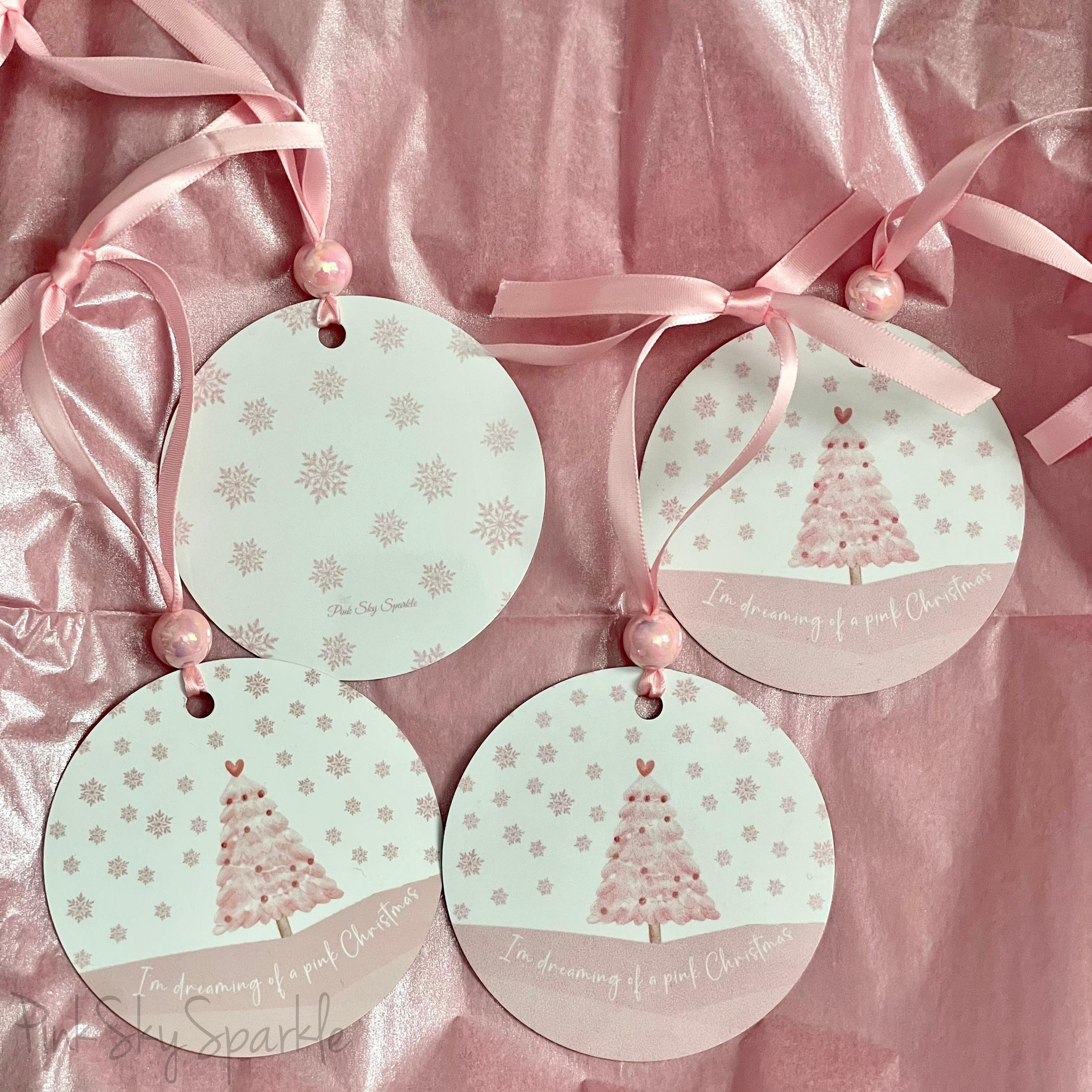 A pink Christmas tree ornament with soft pastel tones and elegant design, featuring the phrase "I'm Dreaming of a Pink Christmas." Perfect for adding a whimsical touch to holiday decor.