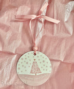 A pink Christmas tree ornament with soft pastel tones and elegant design, featuring the phrase "I'm Dreaming of a Pink Christmas." Perfect for adding a whimsical touch to holiday decor.