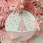 A pink Christmas tree ornament with soft pastel tones and elegant design, featuring the phrase "I'm Dreaming of a Pink Christmas." Perfect for adding a whimsical touch to holiday decor.