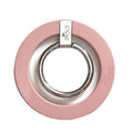Pink ring holder with silver ring on a white background