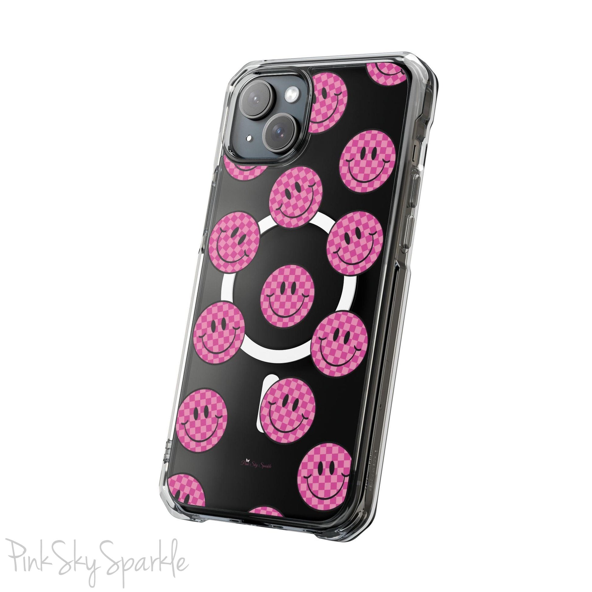 Clear magnetic phone case featuring pink checkered smiley faces on a transparent background, designed for MagSafe® compatibility with air-cushioned bumper corners.
