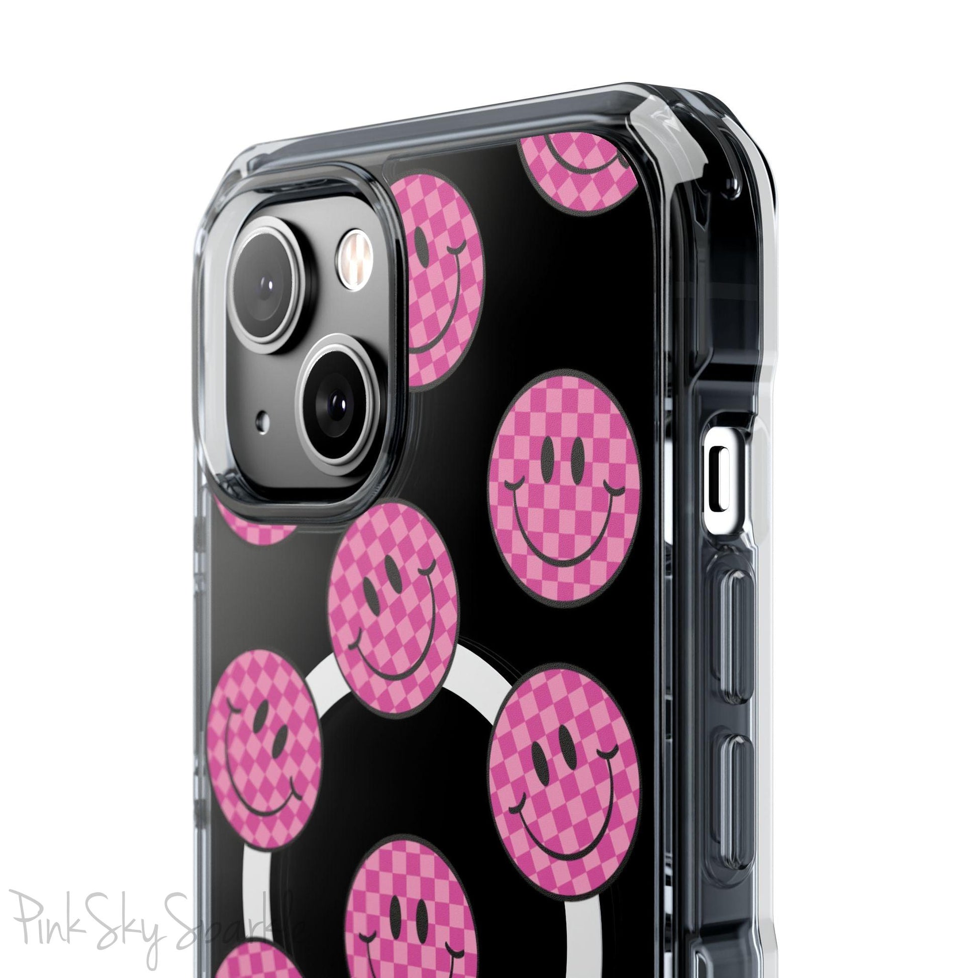 Clear magnetic phone case featuring pink checkered smiley faces on a transparent background, designed for MagSafe® compatibility with air-cushioned bumper corners.